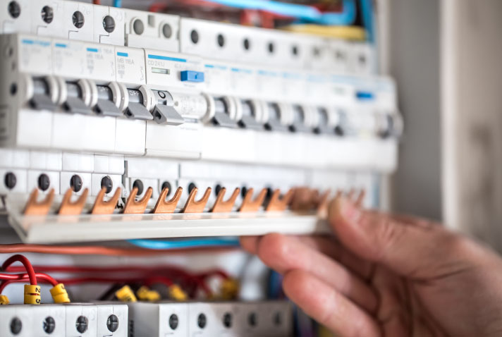 man-electrical-technician-working-switchboard-with-fuses-installation